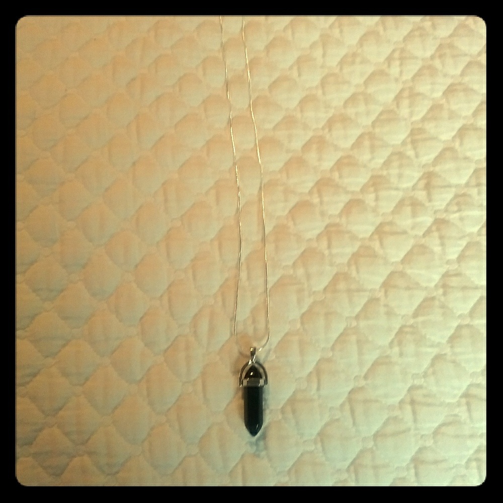 A necklace with obsidian crystal pendant.